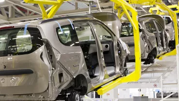 Cars in assembly line at factory.