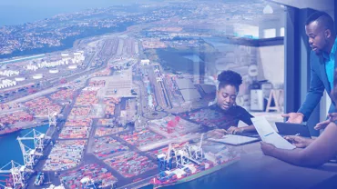 Aerial view of a busy port, overlaid with people discussing documents in an office.