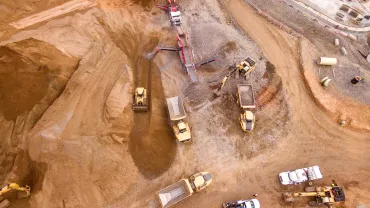 Aerial view of a busy construction site with multiple vehicles and equipment.