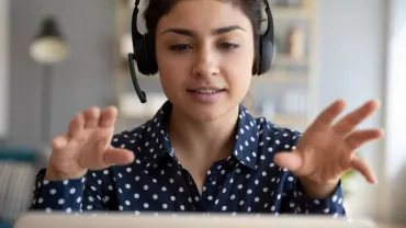 Individual wearing headphones, conducting a video call.